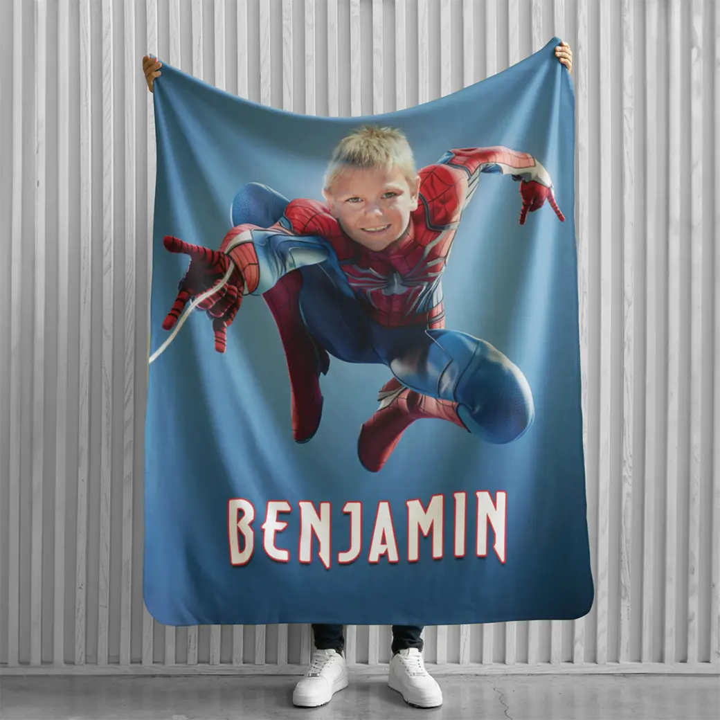 person holding personalized Spiderman blanket
