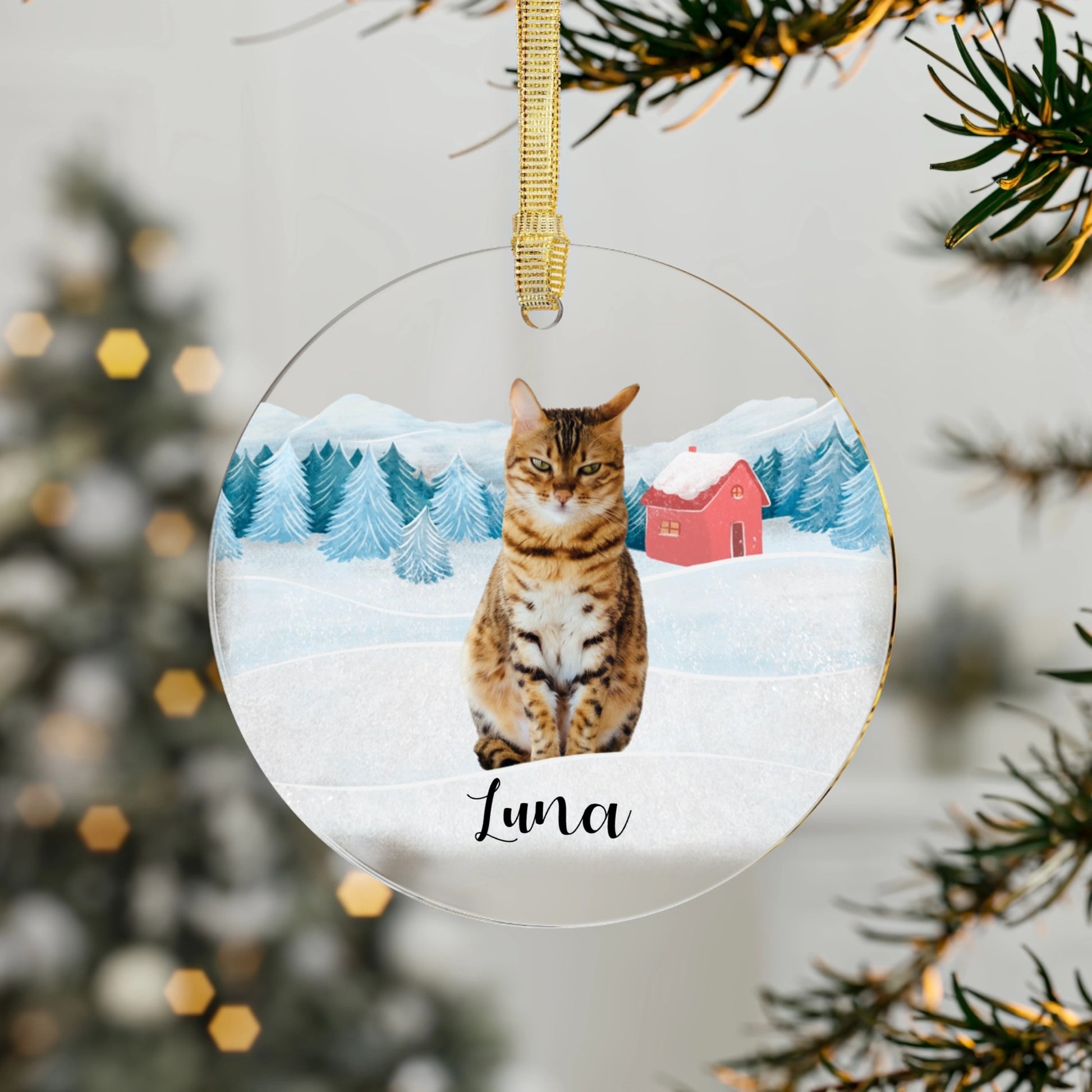Decorative Christmas ornament with a cat named 'Luna' on a snowy landscape background.