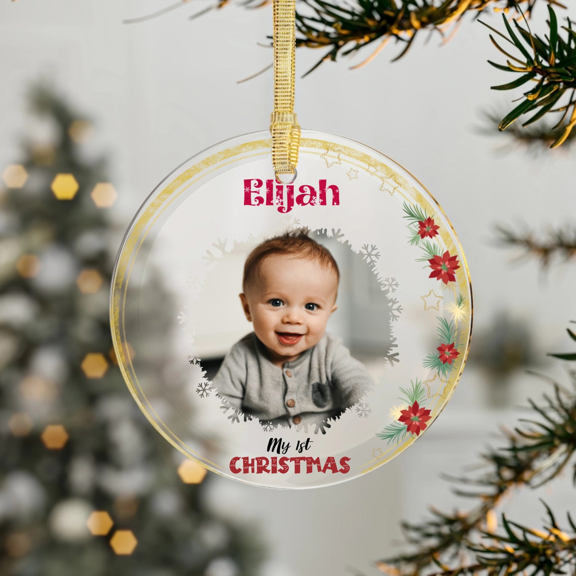 Round baby's first Christmas ornament with a photo and 'My 1st Christmas' text, hanging on a tree.