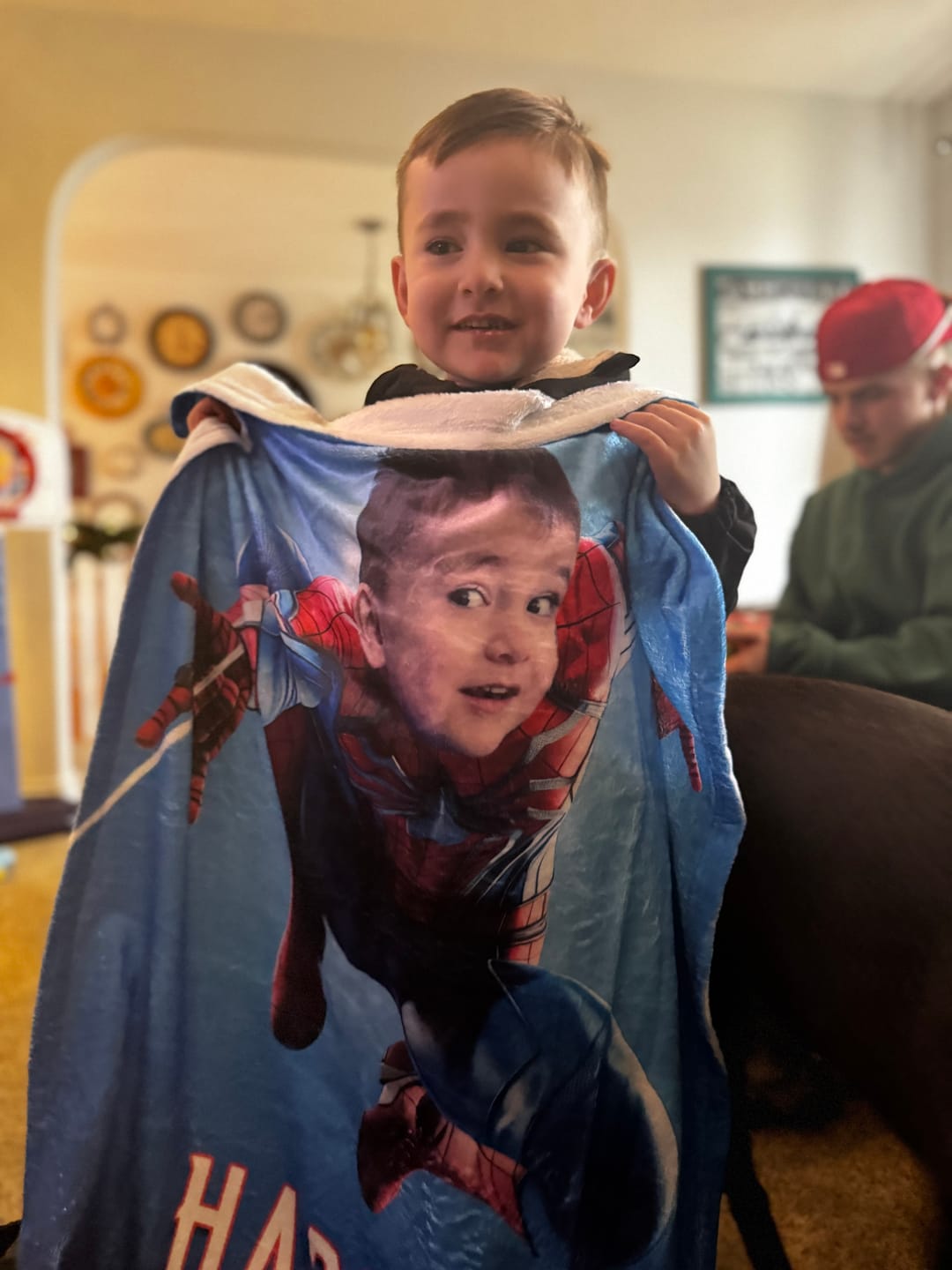 Boy holding superhero Blanket with face and name