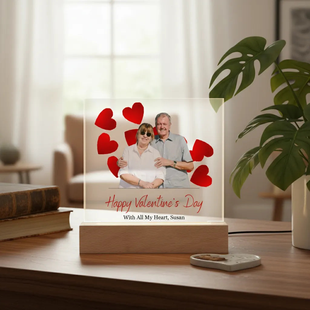 Personalized Valentine's Day photo plaque with a couple and red hearts on a wooden stand.